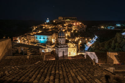 High angle view of illuminated buildings in city at night