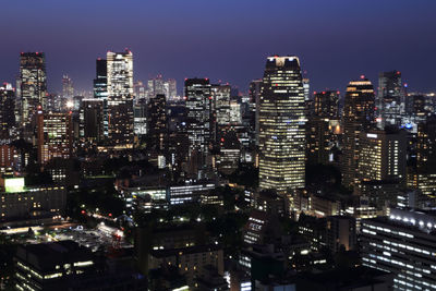 Illuminated cityscape against sky at night