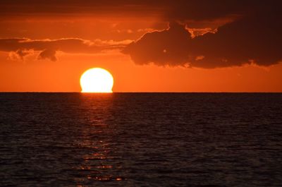 Scenic view of sea against orange sky