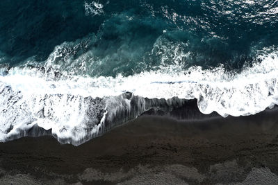 Black beach of volcanic stone and turquoise water. pure power and history combined. 