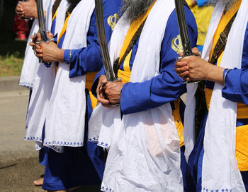 Religious ceremony with sikh men and bigswords in hand