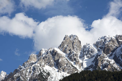 Low angle view of snowcapped mountains against sky