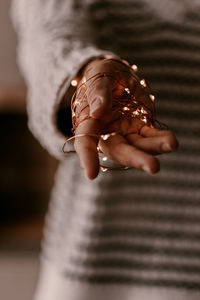 Close-up of woman holding hands at home