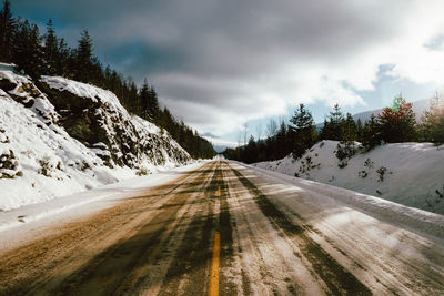 Road amidst trees against sky