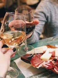 Couple toasting wineglasses at table in restaurant