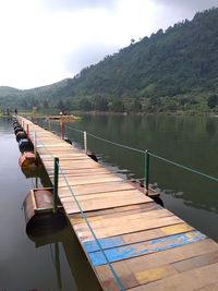 Pier over lake against sky