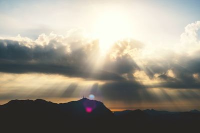 Scenic view of mountains against cloudy sky