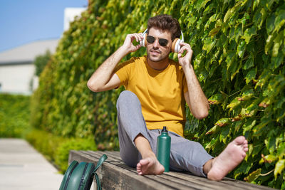 Portrait of young man sitting outdoors