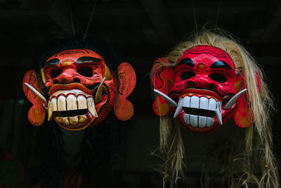 Close-up of masks against black background