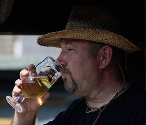 Side view of man drinking cider