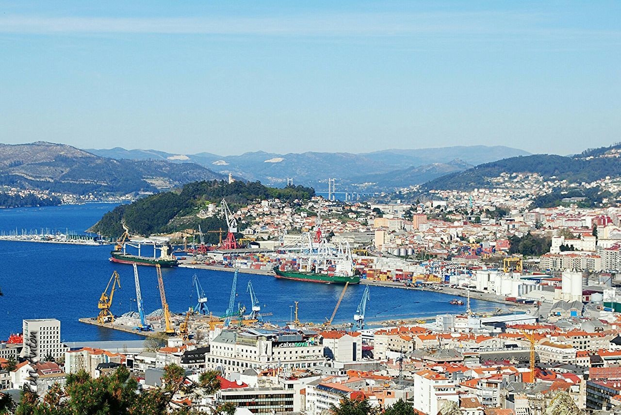 VIEW OF CITYSCAPE WITH RIVER IN FOREGROUND