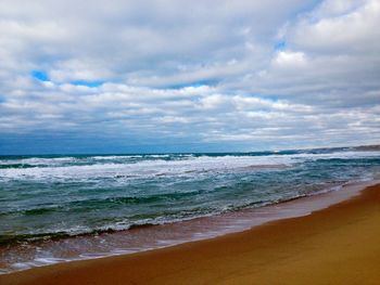 Scenic view of sea against cloudy sky