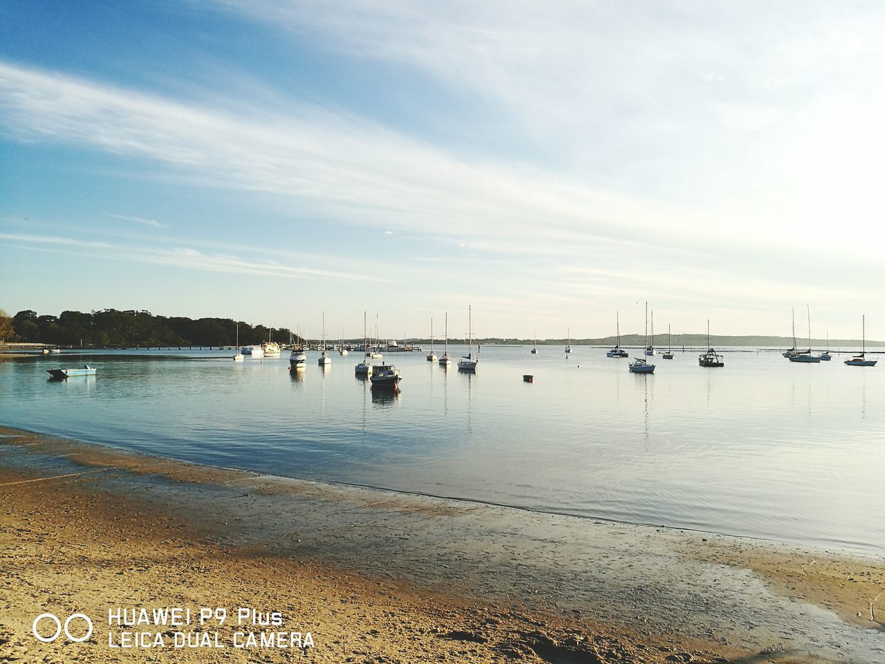 BOATS IN CALM SEA AGAINST SKY