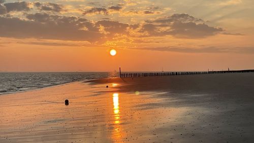 Scenic view of sea against orange sky