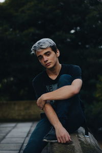 Portrait of young man sitting outdoors