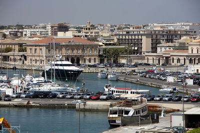 Harbor in city against clear sky