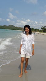 Portrait of woman standing on beach