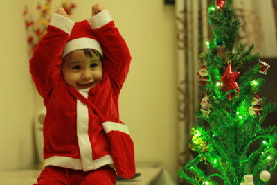 Cute girl with christmas tree at home