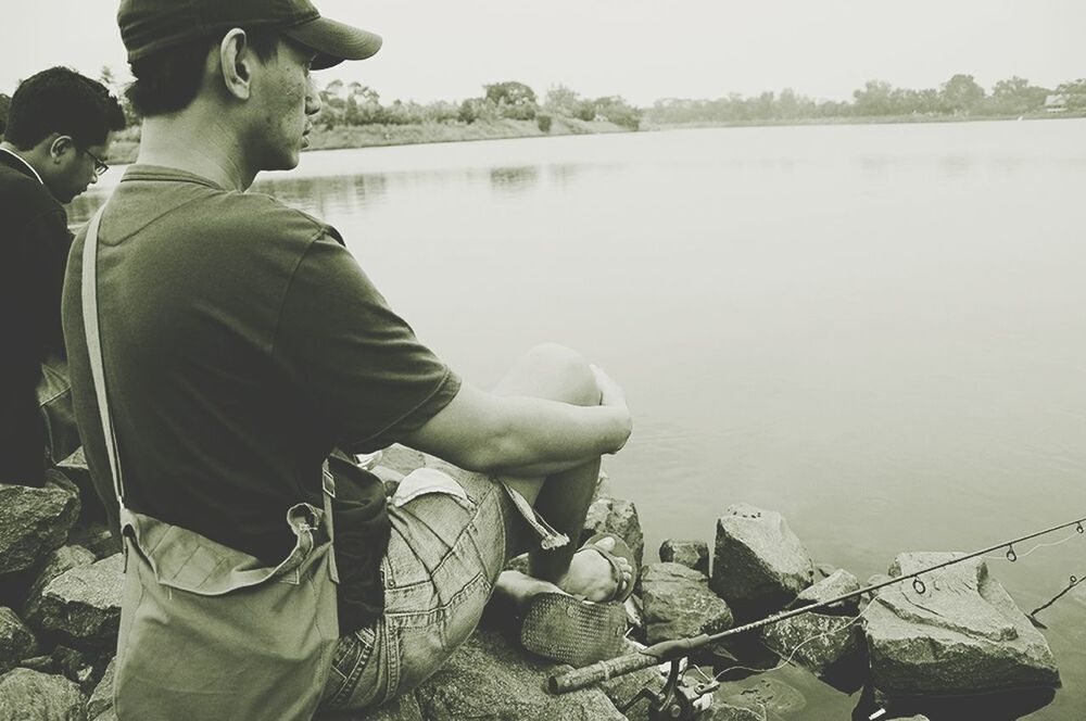 water, lifestyles, leisure activity, men, lake, nautical vessel, casual clothing, river, boat, sitting, rear view, transportation, fishing, mode of transport, nature, standing, day, tranquility