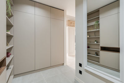 Wardrobe and shelves with decor in the room in a modern style