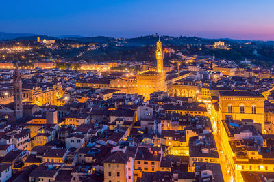 High angle view of city lit up at dusk