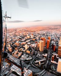 Aerial view of cityscape against sky during sunset