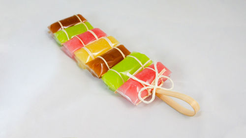 High angle view of candies against white background