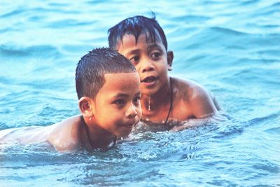 Portrait of smiling boy swimming in pool