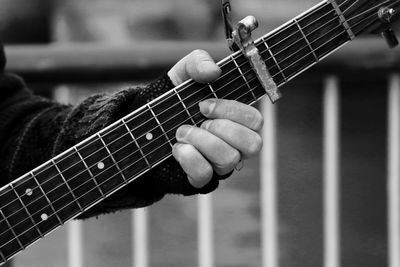 Cropped image of person playing guitar