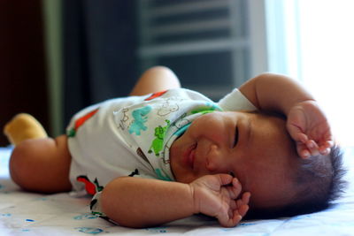 Cute baby sleeping on bed