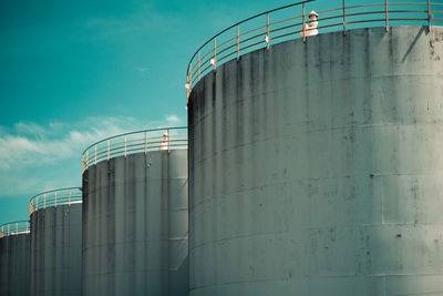 Low angle view of factory against blue sky