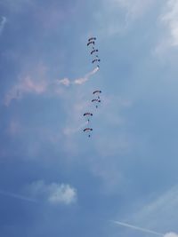 Low angle view of airshow against sky