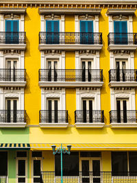 Low angle view of yellow building in city