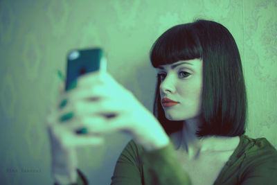 Portrait of young woman using smart phone