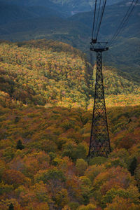 Electricity pylon on landscape during autumn