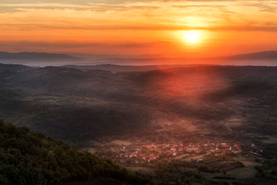 Scenic view of mountains against orange sky