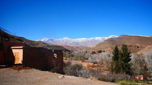 Scenic view of mountains against clear blue sky