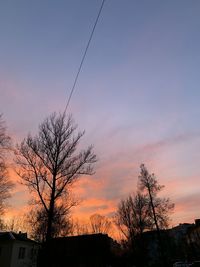 Low angle view of silhouette bare tree against romantic sky