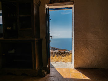 Buildings seen through open window of building