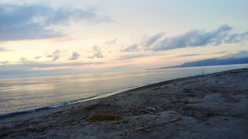 Scenic view of beach against sky during sunset