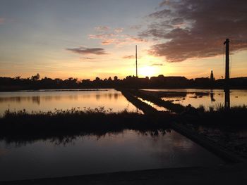 Scenic view of lake against sky during sunset