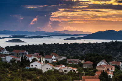 High angle view of townscape and mountains against sky, murter, croatia