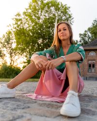 Portrait of woman sitting against trees