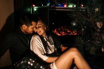 Merry christmas. young couple in love celebrating christmas or new year eve at home. romantic