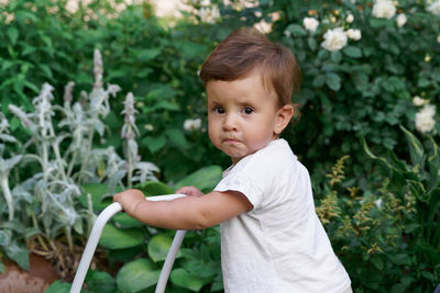 Toddler baby girl first steps in the garden