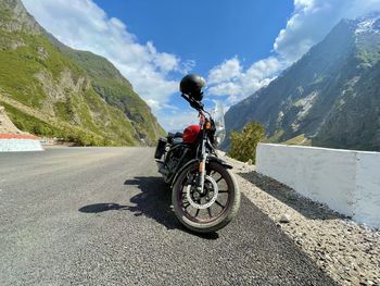 Rear view of man riding bicycle on mountain