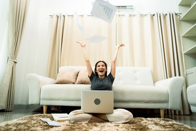 Young woman using laptop at home