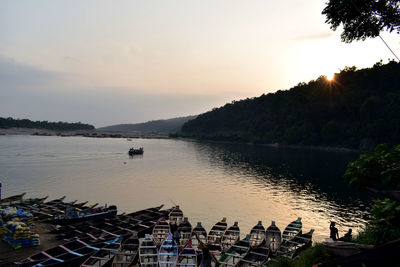 Scenic view of river against sky at sunset