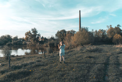 Full length of man standing on field against sky