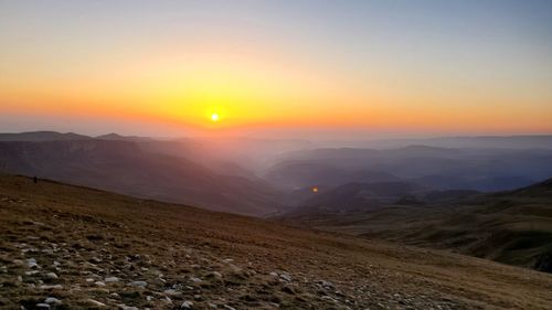 Scenic view of mountains against sky during sunset